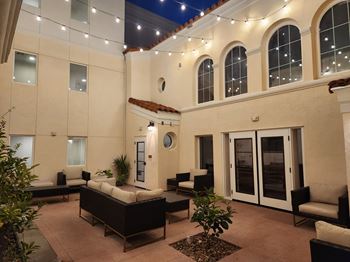 A patio area with a couch, chairs, and a table at Haven at La Mesa, San Diego, CA, 91942